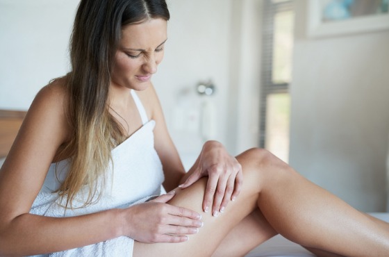 Woman looking at her legs, upset at her cellulite