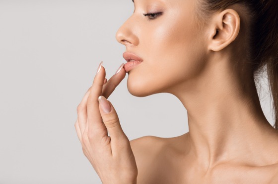 Woman Touching Lips After Receiving Lip Augmentation Treatments