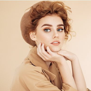 Woman holding her hands under her chin