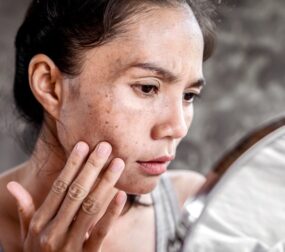 Woman examining her face