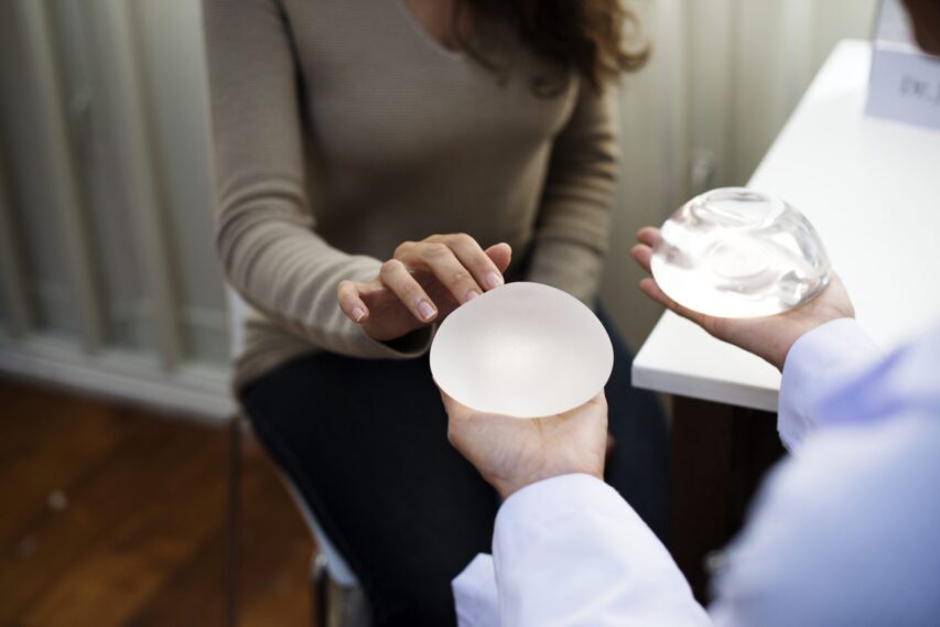Woman picking breast implant