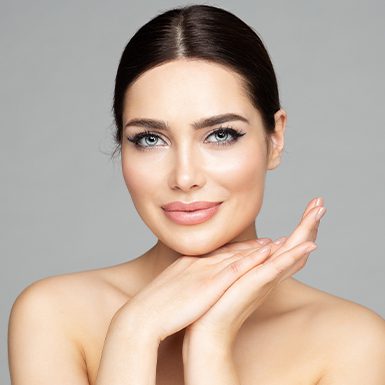Woman resting her chin on folded hands